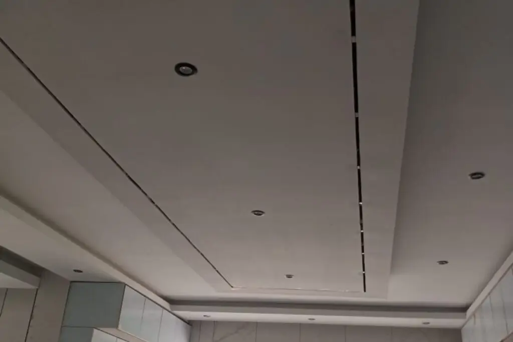 Modern interior showing gypsum ceiling installation with built-in lights