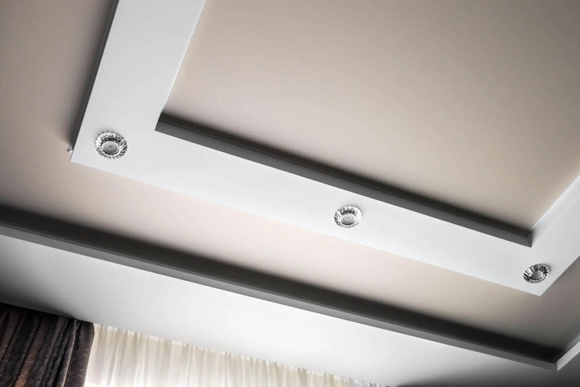 Layered gypsum ceiling design with decorative lighting