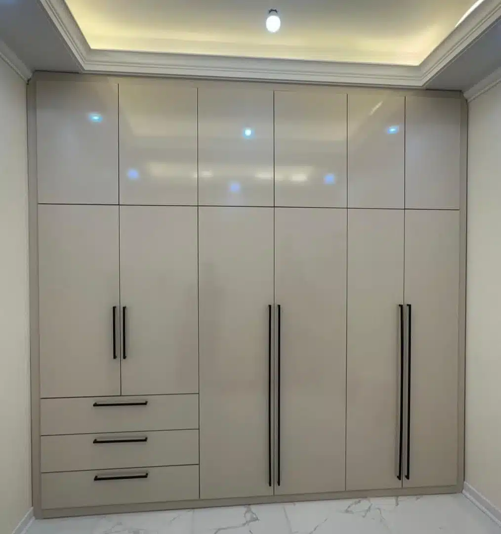 Floor-to-ceiling fitted sliding wardrobe with mirrored panels in a master bedroom in Kenya